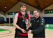 13 March 2024; Griffith College Dublin captain Jim Gormley is presented with the trophy by Niall McDermott of Basketball Ireland after the Basketball Ireland Men's Colleges Division 1 final match between TUS Midwest and Griffith College Dublin at National Basketball Arena in Tallaght, Dublin. Photo by Piaras Ó Mídheach/Sportsfile