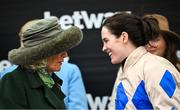 13 March 2024; Queen of the United Kingdom Camilla Parker-Bowles with jockey Rachael Blackmore after she was presented with the trophy after winning the Champion Chase on Captain Guinness during day two of the Cheltenham Racing Festival at Prestbury Park in Cheltenham, England. Photo by David Fitzgerald/Sportsfile