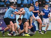 13 March 2024; Herbie Boyle of St Michael’s College is tackled by Francis Nangle, left, and Simon Egan of St Mary’s College during the Bank of Ireland Schools Junior Cup semi-final match between St Michael's College and St Mary's College at Energia Park in Dublin. Photo by Daire Brennan/Sportsfile
