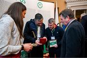 13 March 2024; Olympians and Olympic medallists, from left, Annalise Murphy, Kenneth Egan and Paddy Barnes, admire the medal of David Wilkins, right, at a reception in Trinity College to celebrate 100 years of Team Ireland’s participation at the Olympics, and to officially reveal the names of the athletes who have represented Ireland in the Olympic Games since Ireland first competed as a nation in Paris 1924. Photo by Brendan Moran/Sportsfile