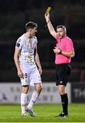 8 March 2024; Sean Boyd of Shelbourne is shown a yellow card by referee Paul McLaughlin during the SSE Airtricity Men's Premier Division match between Bohemians and Shelbourne at Dalymount Park in Dublin. Photo by Stephen McCarthy/Sportsfile