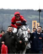 14 March 2024; Jockey Harry Skelton puts a hat on Grey Dawning after winning the Turners Novices' Chase on day three of the Cheltenham Racing Festival at Prestbury Park in Cheltenham, England. Photo by Harry Murphy/Sportsfile
