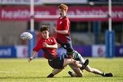 14 March 2024; Sam Cotter of CUS offloads a pass as he is tackled by Noah O'Neill of St Gerard's School during the Bank of Ireland Father Godfrey Cup final match between CUS and St Gerard's School at Energia Park in Dublin. Photo by Ben McShane/Sportsfile