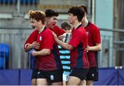 14 March 2024; Sam Cotter of CUS, second from right, celebrates with teammates after scoring their side's third try during the Bank of Ireland Father Godfrey Cup final match between CUS and St Gerard's School at Energia Park in Dublin. Photo by Ben McShane/Sportsfile