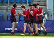 14 March 2024; Sam Cotter of CUS, second from right, celebrates with teammates after scoring their side's third try during the Bank of Ireland Father Godfrey Cup final match between CUS and St Gerard's School at Energia Park in Dublin. Photo by Ben McShane/Sportsfile