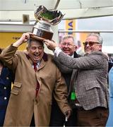 14 March 2024; Joint owners, from left, John Hales, Sir Alex Ferguson and Ged Mason celebrate with the trophy after sending out Protektorat to win the Ryanair Chase on day three of the Cheltenham Racing Festival at Prestbury Park in Cheltenham, England. Photo by Harry Murphy/Sportsfile