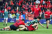 14 March 2024; Finn Byrne, bottom, and Peter Smyth of CUS prevents a try being scored by Brodie McNeill of St Gerard's School during the Bank of Ireland Father Godfrey Cup final match between CUS and St Gerard's School at Energia Park in Dublin. Photo by Ben McShane/Sportsfile