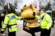15 March 2024; A Gold Cup mascot with police officers before racing on day four of the Cheltenham Racing Festival at Prestbury Park in Cheltenham, England. Photo by Harry Murphy/Sportsfile