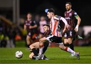 15 March 2024; Adam O'Reilly of Derry City is tackled by Adam McDonnell of Bohemians during the SSE Airtricity Men's Premier Division match between Bohemians and Derry City at Dalymount Park in Dublin. Photo by Stephen McCarthy/Sportsfile