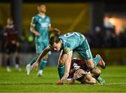 15 March 2024; Daniel Cleary of Shamrock Rovers falls over Edward McCarthy of Galway United during the SSE Airtricity Men's Premier Division match between Galway United and Shamrock Rovers at Eamonn Deacy Park in Galway. Photo by Piaras Ó Mídheach/Sportsfile