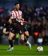 15 March 2024; Jordan Flores of Bohemians in action against Patrick Hoban of Derry City during the SSE Airtricity Men's Premier Division match between Bohemians and Derry City at Dalymount Park in Dublin. Photo by Tyler Miller/Sportsfile