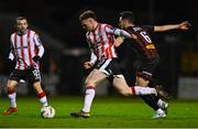 15 March 2024; Cameron McJannet of Derry City in action against Jordan Flores of Bohemians during the SSE Airtricity Men's Premier Division match between Bohemians and Derry City at Dalymount Park in Dublin. Photo by Tyler Miller/Sportsfile
