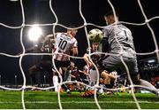 15 March 2024; James Akintunde of Bohemians, back to camera, scores his side's second goal past Derry City goalkeeper Brian Maher during the SSE Airtricity Men's Premier Division match between Bohemians and Derry City at Dalymount Park in Dublin. Photo by Stephen McCarthy/Sportsfile