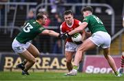 16 March 2024; Sean Powter of Cork is tackled by Shane Walsh, left, and Daithí McGowan of Meath during the Allianz Football League Division 2 match between Meath and Cork at Páirc Tailteann in Navan, Meath. Photo by Ben McShane/Sportsfile