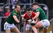 16 March 2024; Sean Powter of Cork is tackled by Shane Walsh, left, and Daithí McGowan of Meath during the Allianz Football League Division 2 match between Meath and Cork at Páirc Tailteann in Navan, Meath. Photo by Ben McShane/Sportsfile