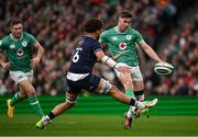 16 March 2024; Jack Crowley of Ireland kicks past Andy Christie of Scotland during the Guinness Six Nations Rugby Championship match between Ireland and Scotland at the Aviva Stadium in Dublin. Photo by Brendan Moran/Sportsfile