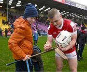 16 March 2024; Tommy O'Connell of Cork signs a hurl after the Allianz Hurling League Division 1 Group A match between Wexford and Cork at Chadwicks Wexford Park in Wexford. Photo by Ray McManus/Sportsfile