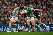 16 March 2024; Robbie Henshaw of Ireland is tackled by Andy Christie of Scotland during the Guinness Six Nations Rugby Championship match between Ireland and Scotland at the Aviva Stadium in Dublin. Photo by Brendan Moran/Sportsfile