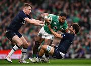 16 March 2024; Bundee Aki of Ireland is tackled by Stafford McDowall, left, and Andy Christie of Scotland during the Guinness Six Nations Rugby Championship match between Ireland and Scotland at the Aviva Stadium in Dublin. Photo by Harry Murphy/Sportsfile