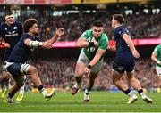 16 March 2024; Dan Sheehan of Ireland evades the tackle of Ben White, right, and Andy Christie of Scotland on his way to scoring his side's first try during the Guinness Six Nations Rugby Championship match between Ireland and Scotland at the Aviva Stadium in Dublin. Photo by Harry Murphy/Sportsfile