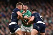 16 March 2024; James Lowe of Ireland is tackled by Duhan van der Merwe, left, and Huw Jones of Scotland during the Guinness Six Nations Rugby Championship match between Ireland and Scotland at the Aviva Stadium in Dublin. Photo by Harry Murphy/Sportsfile