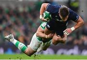 16 March 2024; Huw Jones of Scotland is tackled by Robbie Henshaw of Ireland during the Guinness Six Nations Rugby Championship match between Ireland and Scotland at the Aviva Stadium in Dublin. Photo by Sam Barnes/Sportsfile