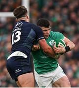 16 March 2024; Calvin Nash of Ireland is tackled by Huw Jones of Scotland during the Guinness Six Nations Rugby Championship match between Ireland and Scotland at the Aviva Stadium in Dublin. Photo by Brendan Moran/Sportsfile