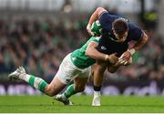 16 March 2024; Huw Jones of Scotland is tackled by Robbie Henshaw of Ireland during the Guinness Six Nations Rugby Championship match between Ireland and Scotland at the Aviva Stadium in Dublin. Photo by Sam Barnes/Sportsfile