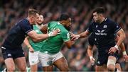 16 March 2024; Bundee Aki of Ireland is tackled by Stafford McDowall, left, and Blair Kinghorn of Scotland during the Guinness Six Nations Rugby Championship match between Ireland and Scotland at the Aviva Stadium in Dublin. Photo by Brendan Moran/Sportsfile