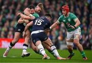16 March 2024; Robbie Henshaw of Ireland is tackled by Kyle Steyn, left, and Blair Kinghorn of Scotland during the Guinness Six Nations Rugby Championship match between Ireland and Scotland at the Aviva Stadium in Dublin. Photo by Brendan Moran/Sportsfile