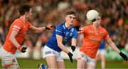 16 March 2024; Tiarnan Madden of Cavan in action against Aiden Forker and Conor Turbitt of Armagh during the Allianz Football League Division 2 match between Armagh and Cavan at BOX-IT Athletic Grounds in Armagh. Photo by Oliver McVeigh/Sportsfile