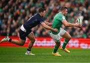 16 March 2024; Jordan Larmour of Ireland is tackled by Ben White of Scotland during the Guinness Six Nations Rugby Championship match between Ireland and Scotland at the Aviva Stadium in Dublin. Photo by Brendan Moran/Sportsfile