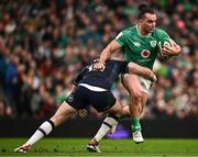 16 March 2024; James Lowe of Ireland is tackled by Stafford McDowall of Scotland during the Guinness Six Nations Rugby Championship match between Ireland and Scotland at the Aviva Stadium in Dublin. Photo by Harry Murphy/Sportsfile