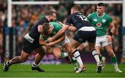 16 March 2024; Jack Crowley of Ireland is tackled by Pierre Schoeman, left, and Stafford McDowall of Scotland during the Guinness Six Nations Rugby Championship match between Ireland and Scotland at the Aviva Stadium in Dublin. Photo by Brendan Moran/Sportsfile