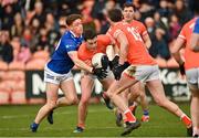 16 March 2024; Aaron McKay of Armagh in action against Ciarán Brady of Cavan during the Allianz Football League Division 2 match between Armagh and Cavan at BOX-IT Athletic Grounds in Armagh. Photo by Oliver McVeigh/Sportsfile