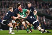 16 March 2024; Josh van der Flier of Ireland is tackled by Scotland players, from left, Kyle Steyn, Andy Christie, and Rory Sutherland during the Guinness Six Nations Rugby Championship match between Ireland and Scotland at the Aviva Stadium in Dublin. Photo by Harry Murphy/Sportsfile