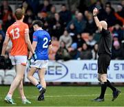 16 March 2024; Referee Liam Devanney issues a black card to Cian Reilly of Cavan during the Allianz Football League Division 2 match between Armagh and Cavan at BOX-IT Athletic Grounds in Armagh. Photo by Oliver McVeigh/Sportsfile