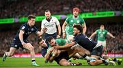 16 March 2024; Robbie Henshaw of Ireland is held up by Scotland players from left, George Horne, Cameron Redpath, and Andy Christie during the Guinness Six Nations Rugby Championship match between Ireland and Scotland at the Aviva Stadium in Dublin. Photo by Sam Barnes/Sportsfile