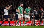 16 March 2024; Harry Byrne of Ireland, right, is shown a yellow card by referee Matthew Carley during the Guinness Six Nations Rugby Championship match between Ireland and Scotland at the Aviva Stadium in Dublin. Photo by Brendan Moran/Sportsfile
