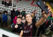 16 March 2024; Fiona Donnelly of Bohemians takes a selfie with a supporter after the SSE Airtricity Women's Premier Division match between Bohemians and Athlone Town at Dalymount Park in Dublin. Photo by Jussi Eskola/Sportsfile