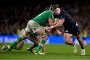16 March 2024; Huw Jones of Scotland is tackled by Caelan Doris of Ireland during the Guinness Six Nations Rugby Championship match between Ireland and Scotland at the Aviva Stadium in Dublin. Photo by Brendan Moran/Sportsfile