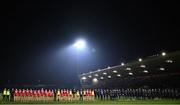 16 March 2024; The Tyrone team and backroom staff stand for a minute's silence in memory of the late Caolan Devlin, brother of Tyrone player Niall Devlin, before the Allianz Football League Division 1 match between Tyrone and Monaghan at O'Neills Healy Park in Omagh, Tyrone.  Photo by Ramsey Cardy/Sportsfile