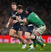 16 March 2024; George Horne of Scotland is tackled by Ryan Baird of Ireland during the Guinness Six Nations Rugby Championship match between Ireland and Scotland at the Aviva Stadium in Dublin. Photo by Brendan Moran/Sportsfile