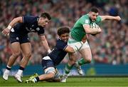 16 March 2024; Robbie Henshaw of Ireland is tackled by Rory Darge of Scotland during the Guinness Six Nations Rugby Championship match between Ireland and Scotland at the Aviva Stadium in Dublin. Photo by Harry Murphy/Sportsfile