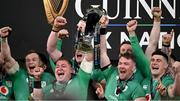 16 March 2024; Ireland captain Peter O'Mahony, second from right, and teammates Josh van der Flier, Tadhg Furlong and Dan Sheehan celebrate with the Six Nations trophy after the Guinness Six Nations Rugby Championship match between Ireland and Scotland at the Aviva Stadium in Dublin. Photo by Brendan Moran/Sportsfile