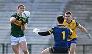 17 March 2024; Joe O'Connor of Kerry scores a point past Roscommon goalkeeper Conor Carroll during the Allianz Football League Division 1 match between Roscommon and Kerry at Dr Hyde Park in Roscommon. Photo by Ben McShane/Sportsfile