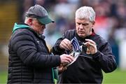 17 March 2024; Mayo manager Kevin McStay inspects the matchday programme with Mayo GAA public relations officer John Walker, left, before the Allianz Football League Division 1 match between Mayo and Derry at Hastings Insurance MacHale Park in Castlebar, Mayo. Photo by Piaras Ó Mídheach/Sportsfile
