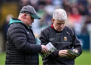 17 March 2024; Mayo manager Kevin McStay inspects the matchday programme with Mayo GAA public relations officer John Walker, left, before the Allianz Football League Division 1 match between Mayo and Derry at Hastings Insurance MacHale Park in Castlebar, Mayo. Photo by Piaras Ó Mídheach/Sportsfile