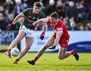 17 March 2024; Jordan Flynn of Mayo in action against Ciarán McFaul of Derry during the Allianz Football League Division 1 match between Mayo and Derry at Hastings Insurance MacHale Park in Castlebar, Mayo. Photo by Piaras Ó Mídheach/Sportsfile