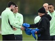 18 March 2024; Technical advisor Brian Kerr hands a bib to Finn Azaz during a Republic of Ireland training session at the FAI National Training Centre in Abbotstown, Dublin. Photo by Stephen McCarthy/Sportsfile